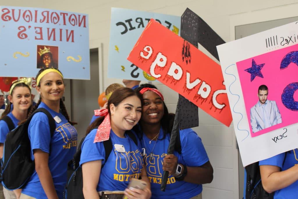 Orientation Leaders holding signs for their orientation groups.